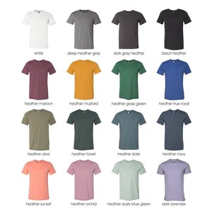 May include: A selection of 14 t-shirts in various colors and heather shades, including white, deep heather gray, dark gray heather, black heather, heather maroon, heather mustard, heather grass green, heather true royal, heather olive, heather forest, heather slate, heather navy, heather sunset, heather orchid, heather dusty blue green, and dark lavender.