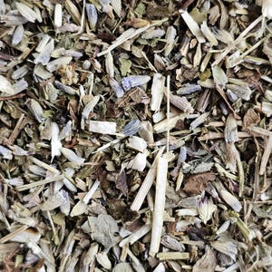May include: A close-up of a blend of dried herbs and flowers, including lavender, for making herbal tea. The mixture is a mix of light brown, green, and purple hues.