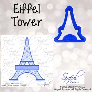 以下が含まれることがあります： エッフェル塔の形をした青いプラスチック製のクッキーカッター。カッターは青と白のパターンが施された白い背景の上にあります。