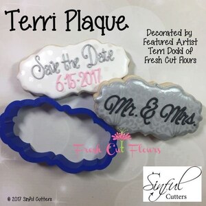 May include: Image of a cookie cutter and decorated cookies. The cookies are cloud-shaped with text that reads "Save the Date 6-15-2017" and "Mr. & Mrs." A blue cookie cutter is also visible. The text "Terri Plaque" is at the top.