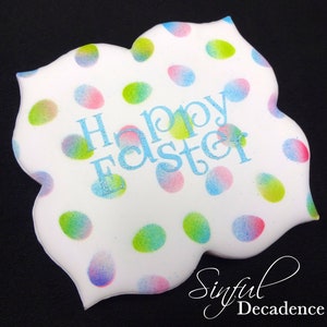 May include: A white, uniquely shaped cookie decorated with pastel-colored egg-shaped polka dots. The words "Happy Easter" are written in light blue glittery script across the center. The cookie has a black background and the words "Sinful Decadence" in script.