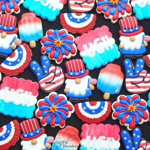 May include: A collection of decorated sugar cookies featuring patriotic themes, including fireworks, gnomes, peace signs, and popsicles. The cookies are decorated in red, white, and blue with stars and stripes.