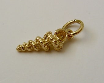 May include: Gold-toned seashell charm with a spiral design and a jump ring for attaching to a necklace or bracelet.