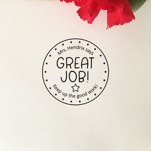 May include: Black and white round stamp with the text "Mrs. Hendrix says GREAT JOB! Keep up the good work!" and a star in the center.