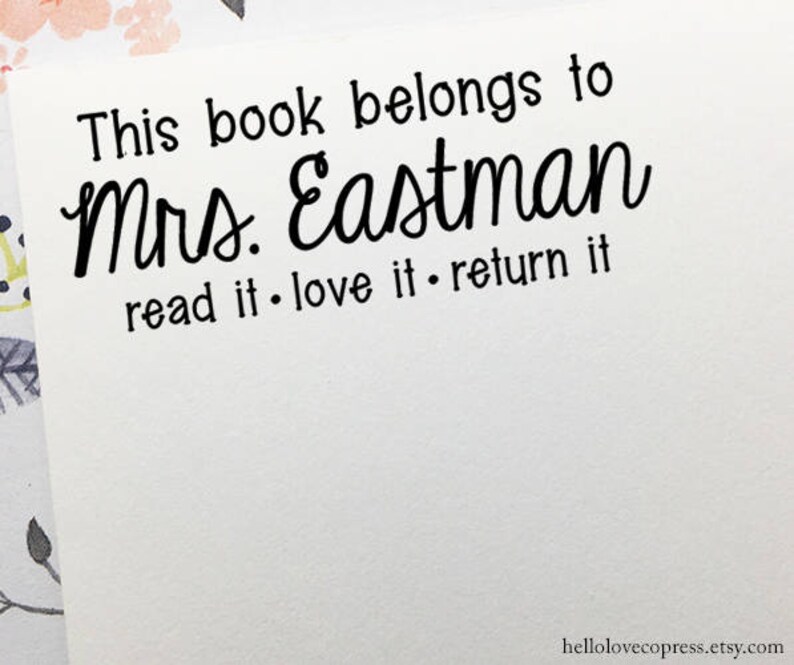 May include: A white card with black text that reads "This book belongs to Mrs. Eastman read it. love it. return it".