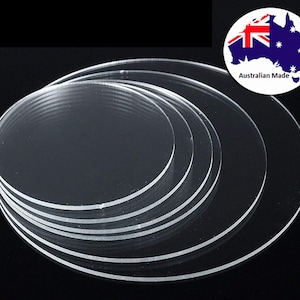 May include: A stack of clear, circular acrylic discs of varying sizes. The transparent material allows light to pass through, creating a clean and modern aesthetic. The image includes a small Australian Made logo.