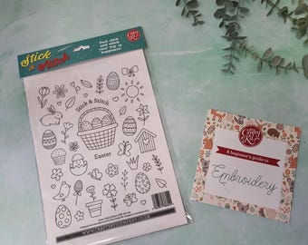 May include: A white sheet with black and white Easter-themed illustrations, including eggs, bunnies, flowers, and a basket. The sheet is labelled "Stick & Stitch Easter" and has the website "www.craftykitcompany.co.uk". A small card with a floral pattern and the text "A beginner's guide to Embroidery" is also shown.