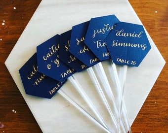 Navy Hexagon Cocktail Stirrers Place Cards | Champagne Flute Glass Escort Cards | Sip and Be Seated Wedding Theme | Calligraphy Place Cards.