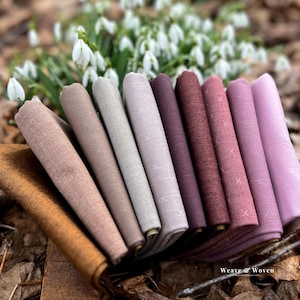May include: A set of three ceramic mugs with a speckled, matte finish. The mugs are in shades of cream, light grey, and dark grey. Each mug has a simple, minimalist design and a rounded handle. Suitable for coffee or tea.