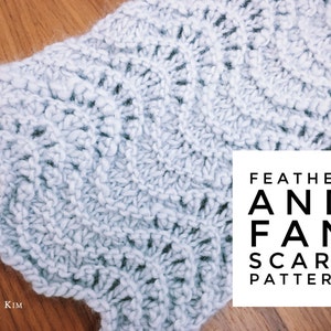 May include: A close-up of a light blue knitted scarf with a feather and fan stitch pattern. The text "FEATHER AND FAN SCARF PATTERN" is printed on a white square.