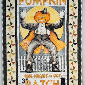 May include: A Halloween-themed quilt featuring a pumpkin-headed scarecrow in a suit, with the words "Pumpkin Patch" and "One Night in Oct." A black cat is at the bottom. The quilt has a patterned border with colorful triangles.
