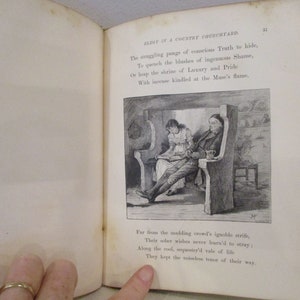 May include: A black and white illustration of a man and a woman sitting in a church pew. The man is reading a book and the woman is looking at him. The text "ELEGY IN A COUNTRY CHURCHYARD" is visible at the top of the page.