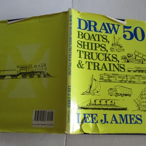May include: A yellow book cover with the title "Draw 50 Boats, Ships, Trucks, & Trains" by Lee J. Ames. The cover features illustrations of various boats, ships, trucks, and trains.