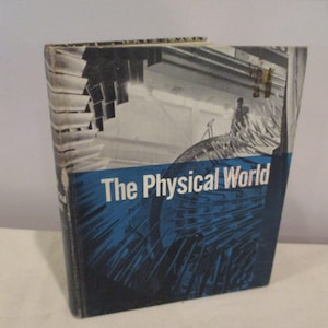 May include: A blue and white book with the title "The Physical World" on the cover. The cover features a close-up of a metal structure.