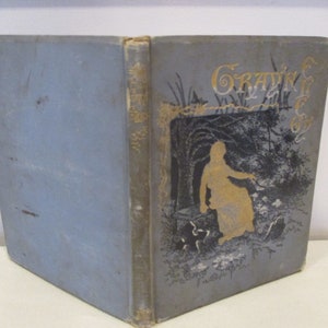 May include: A blue book with gold lettering on the cover. The title of the book is "Graving for the  " and the cover features a black and white illustration of a woman in a woodland setting.