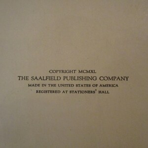 May include: A close-up of a beige paper with black text. The text reads "COPYRIGHT MCMXL THE SAALFIELD PUBLISHING COMPANY MADE IN THE UNITED STATES OF AMERICA REGISTERED AT STATIONERS' HALL."