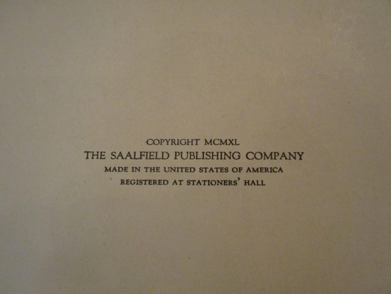 May include: A close-up of a beige paper with black text. The text reads "COPYRIGHT MCMXL THE SAALFIELD PUBLISHING COMPANY MADE IN THE UNITED STATES OF AMERICA REGISTERED AT STATIONERS' HALL."