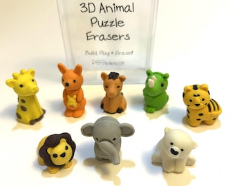 May include: A collection of colorful 3D animal puzzle erasers. The set includes a giraffe, kangaroo, horse, rhino, tiger, lion, elephant, and polar bear. The erasers are in various colors, including yellow, orange, green, and gray.