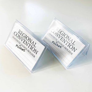 May include: Two clear plastic badge holders with the text "Regional Convention Magnetic Badge Holder Pocket" printed on the front.
