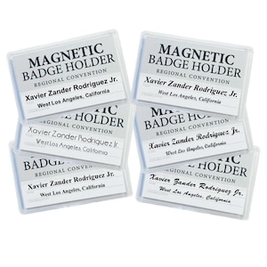 May include: Six clear plastic magnetic badge holders with the text "MAGNETIC BADGE HOLDER" and "REGIONAL CONVENTION" printed on them. Each holder has the name "Xavier Zander Rodriguez Jr." and the location "West Los Angeles, California" printed on a white card inside.