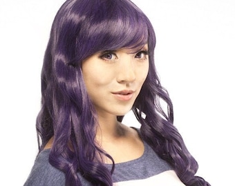May include: A long, wavy, purple wig with bangs. The wig is styled in loose curls and falls to the shoulders.