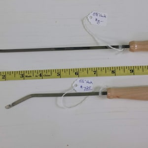 May include: Two metal hooks with wooden handles. The top hook is 8 1/2 inches long and costs $8. The bottom hook is 5 1/2 inches long and costs $7.25.