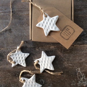 Handmade ceramic white star ornament with daisy design. Christmas gift tags, decorations, wedding, favours. Made with white clay