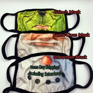 May include: Three reusable face masks with different holiday character designs. The top mask features the Grinch, the middle mask features Santa Claus, and the bottom mask features a snowman. The text "Same Day Shipping! Including Saturdays!" is printed on the bottom mask.