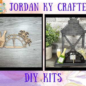 May include: Two DIY craft kits for New Year's Eve decorations. The first kit features a wooden clock face with a champagne bottle and glass, and fireworks. The second kit features a wooden lantern with a champagne bottle and glass, and fireworks.