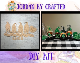 May include: A DIY craft kit featuring four unfinished wooden gnome figures with the word "LUCK" and a shamrock heart. The kit includes all the pieces needed to create a festive St. Patrick's Day decoration.