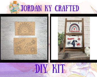 May include: A DIY craft kit for making a 4th of July sign. The kit includes two wooden pieces with cutouts for a rainbow, stars, fireworks, and the number 4. The sign says "Happy 4th" and "America".