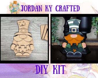 May include: A DIY kit for crafting a leprechaun gnome. The kit includes unfinished wood pieces of a gnome with a hat, beard, and shamrocks. The finished gnome is shown on the right side of the image, painted in green, orange, and white.