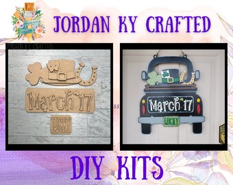 May include: Two DIY craft kits for St. Patrick's Day. The first kit features a leprechaun hat, shamrock, horseshoe, and sign that says "March 17" and "Lucky". The second kit features a black truck with a leprechaun hat, shamrock, horseshoe, and sign that says "March 17".