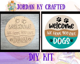May include: DIY kit for a welcome sign with a dog paw print design. The sign says "Welcome, we hope you like dogs".