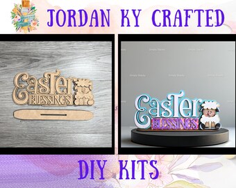 May include: Two DIY Easter craft kits featuring the words "Easter Blessings" with a lamb. The kit on the left is unpainted and the kit on the right is painted in shades of blue, purple, and white.