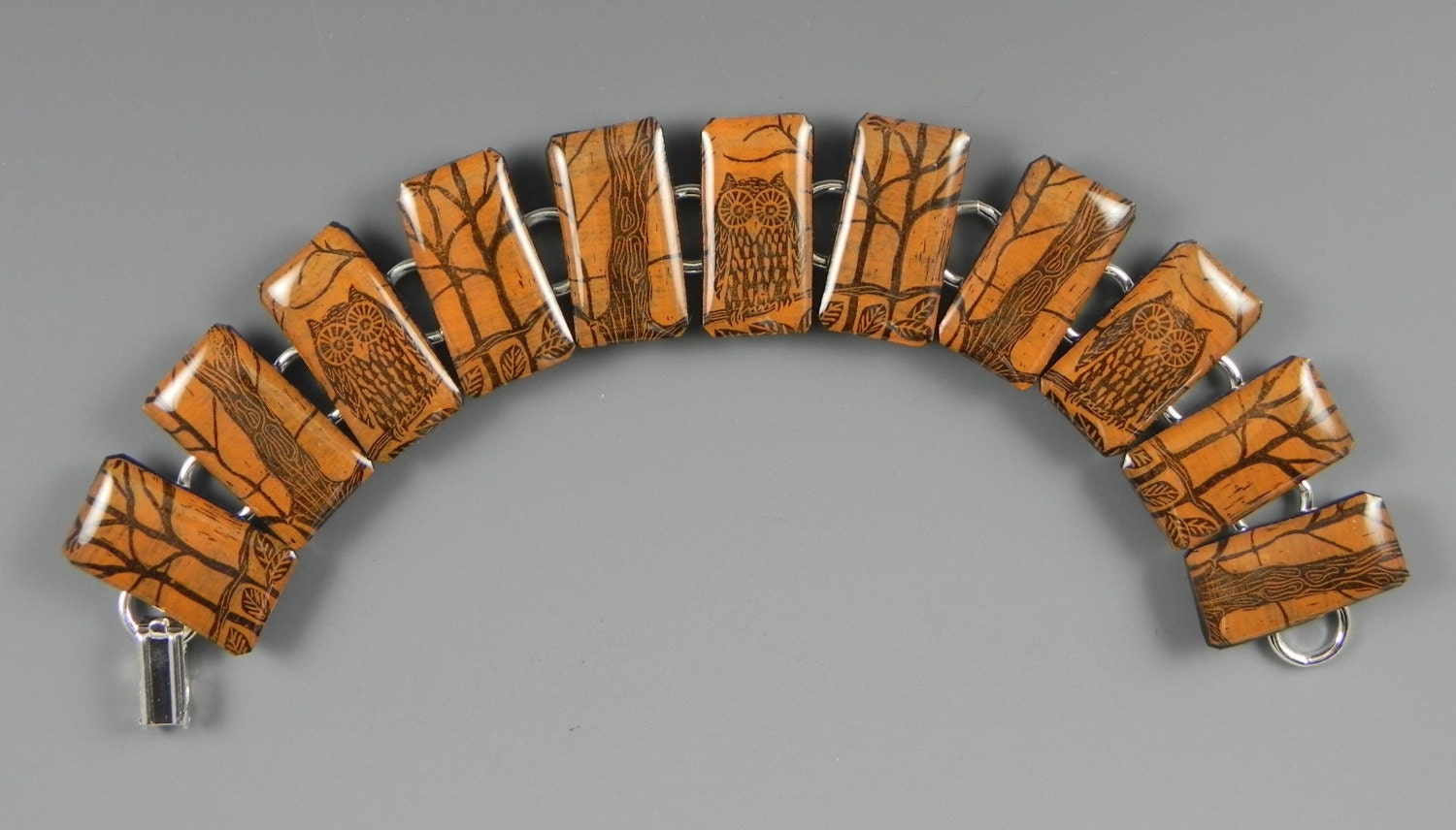 This orange owl bracelet was designed by carving out a block and printing the image on polymer.  A r
