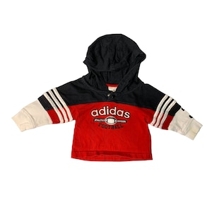 May include: Red and navy blue hooded sweatshirt with white stripes on the sleeves. The sweatshirt has the Adidas logo and the words "Athletic Division Football" on the front.