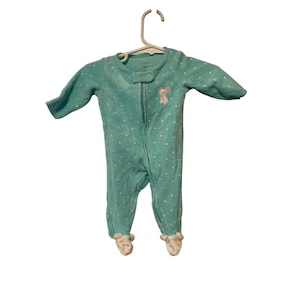 May include: A teal baby sleeper with white polka dots and a zipper closure. The sleeper features a small embroidered mouse design and foot coverings with a cream-colored mouse face.