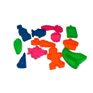 May include: A set of 12 colorful plastic cookie cutters in various shapes, including a bottle, fish, carrot, apple, cupcake, leaf, grapes, gingerbread man, and a boot. The cutters are perfect for making fun and festive cookies.