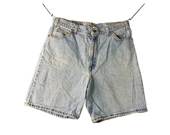 May include: Light blue denim shorts with a button and zipper closure. The shorts have five pockets and a faded look.