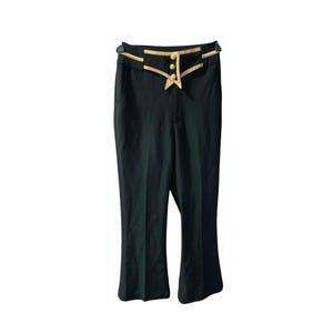 May include: Black flared pants with a high waist and a gold trim around the waistband. The waistband has three gold buttons.