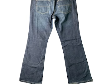 May include: A pair of dark blue denim jeans with a bootcut leg style.