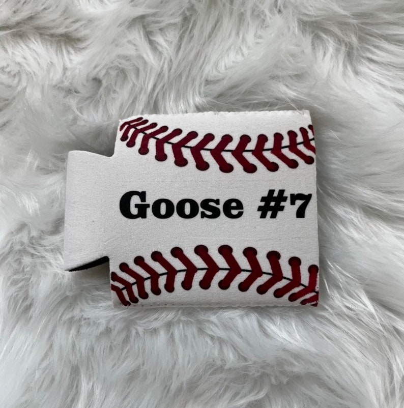 May include: White foam can cooler with a baseball design. The cooler has red stitching and the text "Goose #7" printed on it.