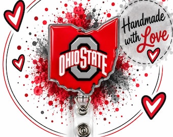 May include: A red Ohio State University logo badge reel shaped like the state of Ohio. The design features a silver and black block O logo with the text OHIO STATE. The background includes red and black paint splatters and red hearts.