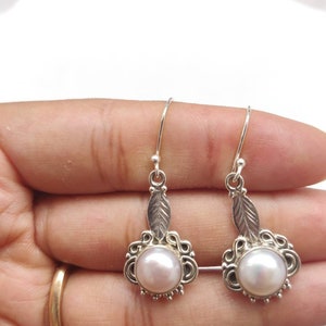 Round shape fresh water pearl studded in leaf carved antique polish Sterling silver earrings,92.5 purity, 25*15mm approx size,silver earwire