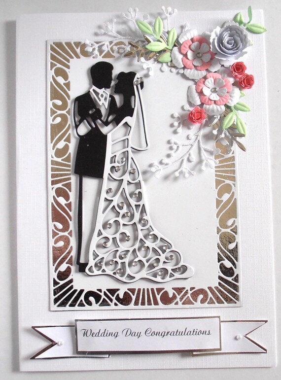 Intricate hand-quilled paper flowers make this wedding card a miniature artwork worth framing, not just opening once and recycling.