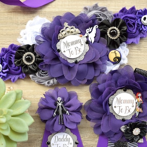 May include: Three purple and black sashes with a white and black striped ribbon. The sashes have a large purple flower with a silver glitter circle that says "Mommy To Be" and a small black flower with a black rhinestone in the center. The sashes are decorated with a black and white Jack Skellington character from the Nightmare Before Christmas.
