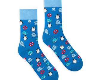 Colourful socks with whale, seal and pinguin on blue background