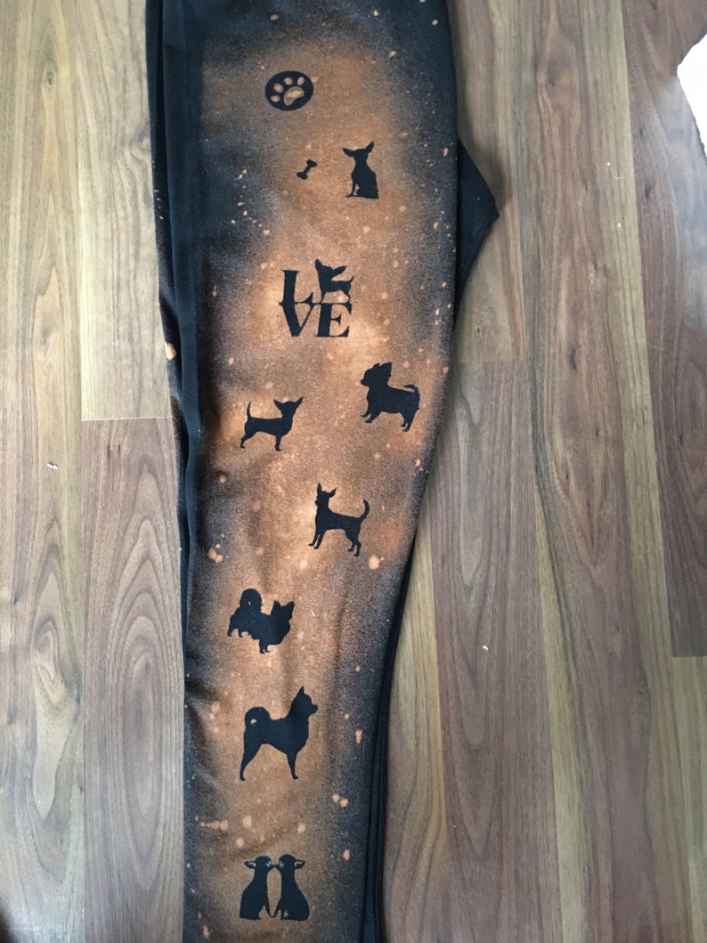 May include: Black leggings with a bleach-splattered design featuring silhouettes of dogs and the word "LOVE".