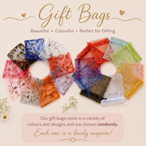 May include: A collection of sheer organza gift bags arranged in two circular groups. The bags feature various heart and swirl patterns in colors including red, blue, pink, orange, yellow, green, and white. Text reads Gift Bags and Our gift bags come in a variety of colours and designs and are chosen randomly. Each one is a lovely surprise!